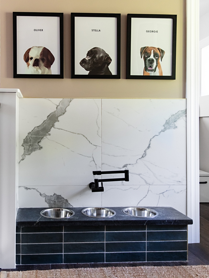 Elevated living extends to every member of the family. A custom dog-feeding station on the other side of the mud area blends high-end finishes with everyday convenience, featuring a wall-mounted water filler, inset stainless steel bowls, and an attractive yet easy-care backsplash.